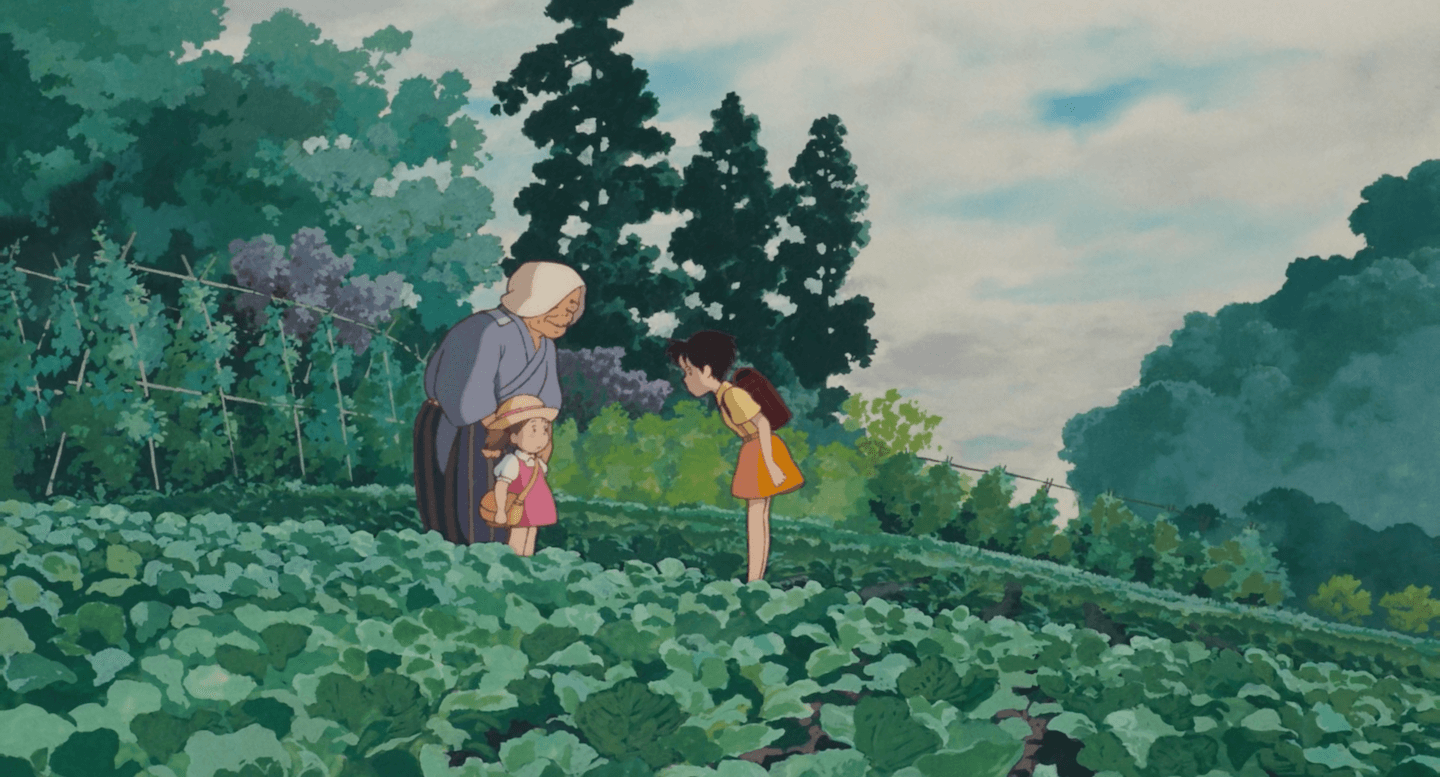 Image of Mei and Satsuke standing in a field of vegetables